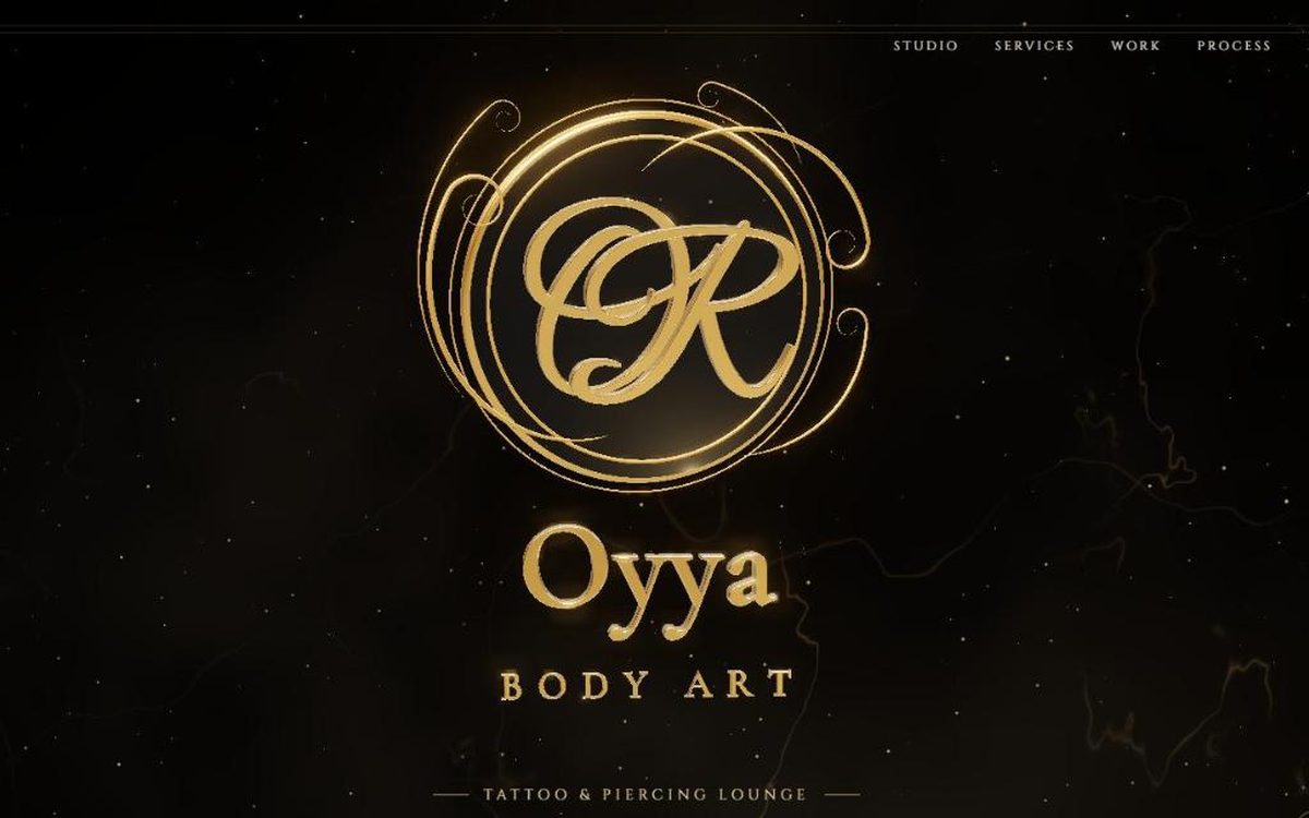 Oyya Body Art website: gold 3D logo on black marble